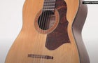 A close-up of an acoustic guitar. 