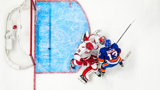 Mathew Barzal #13 of the New York Islanders deflects the puck to score the game-winning goal in overtime against Frederik Andersen #31 of the Carolina Hurricanes in Game Four of the First Round of the 2024 Stanley Cup Playoffs at UBS Arena on April 27, 2024 in Elmont, New York. 
