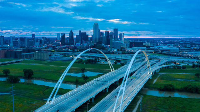 Interstate 30 leads to downtown Dallas, Texas at dusk featuring Margaret Hill Bridge 