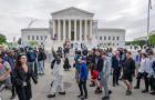 WASHINGTON, DC - APRIL 25: A tour group walks past as protestor 