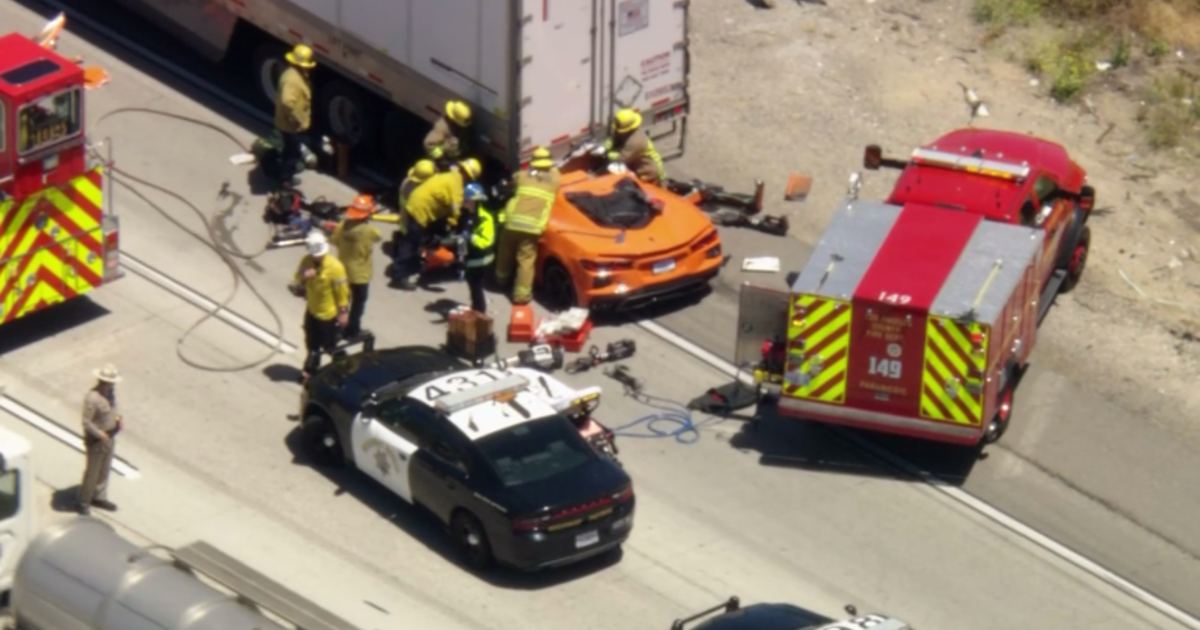 Corvette driver hospitalized after trapped under semi-truck in Castaic – CBS News