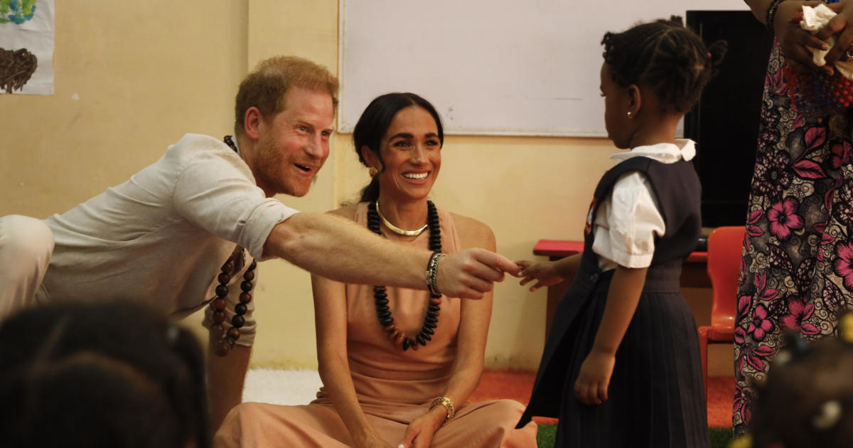 Prince Harry and Meghan visit Nigeria, where the duchess hints at her heritage with students: