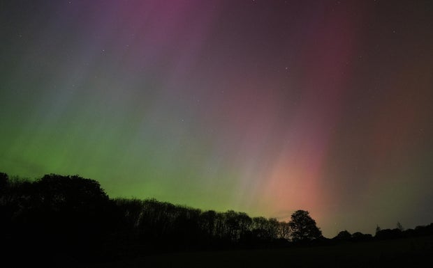 The aurora borealis, also known as the northern lights, glow on the horizon