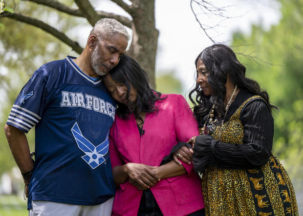 Candace Leslie and her parents at her son Cameron's grave at Crown Hill Cemetery in Indianapolis. Leslie lost her son Cameron in 2021 after he was shot and killed near his apartment complex in Indianapolis. 