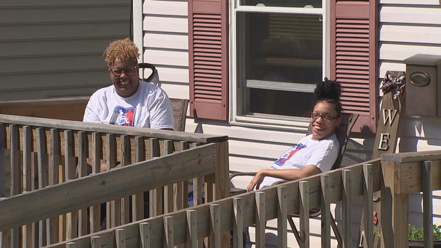 Tanya and Lamoni Green sit on a deck outside 
