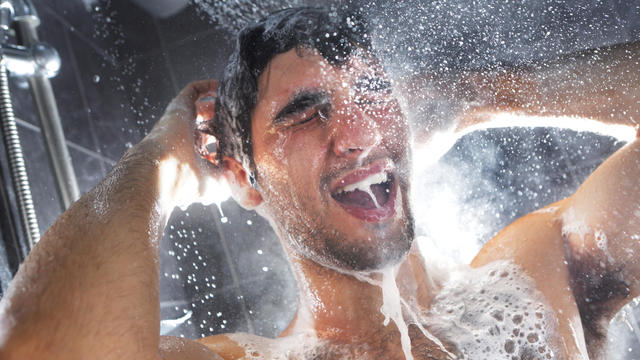 Man in shower, rinsing shampoo from hair 