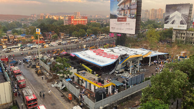 An aerial view shows a fallen billboard on a fuel station following a wind and dust storm in Mumbai 