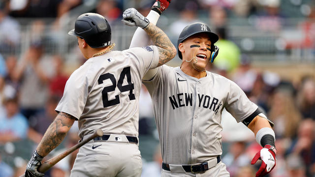 Aaron Judge #99 of the New York Yankees celebrates his solo home run with teammate Alex Verdugo #24 in the first inning against the Minnesota Twins at Target Field on May 15, 2024 in Minneapolis, Minnesota. 
