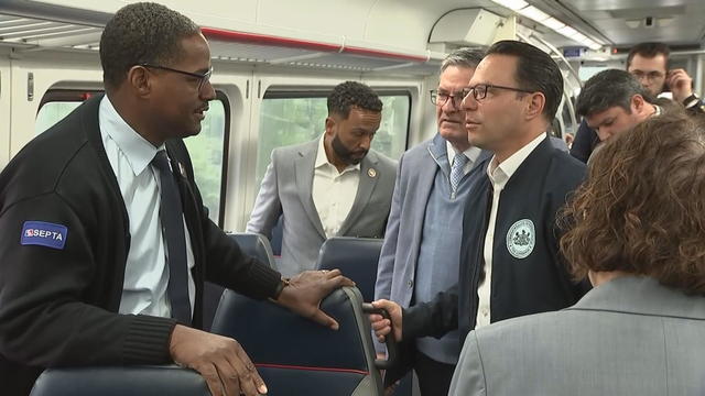Gov. Josh Shapiro speaks to a SEPTA employee on a regional rail train 
