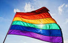 Rainbow LGBTQIA pride flag waving in the wind 