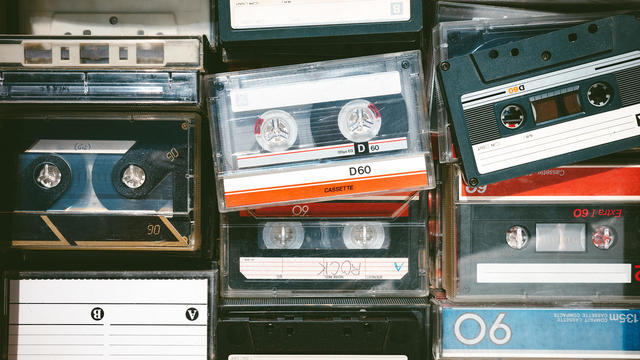 Close-up image of some old obsolete cassette tapes of different colors from above 