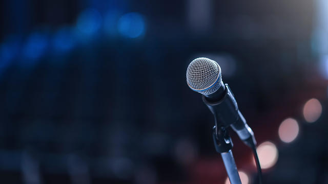 Close up of microphone in concert hall or conference room 