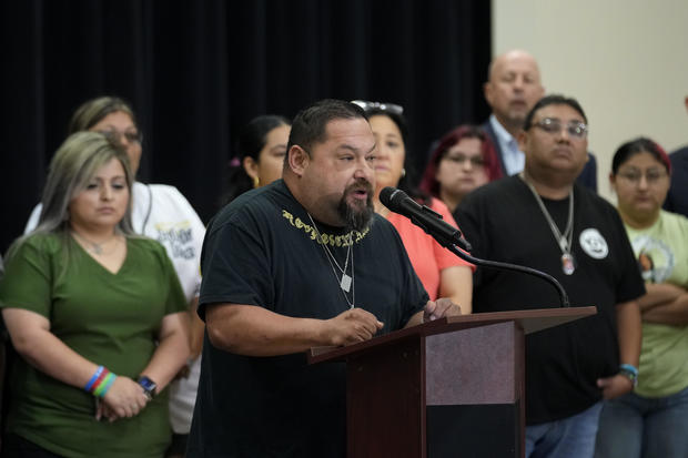 Javier Cazares, center, stands with families of the victims of the Uvalde elementary school shooting during a news conference May 22, 2024, in Uvalde, Texas. 