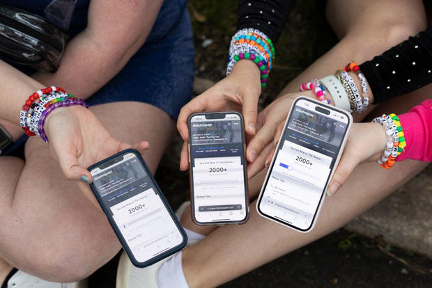 Taylor Swift fans show their Ticketmaster queue from the parking lot outside of a concert at Lincoln Financial Field in Philadelphia on May 13, 2023. 