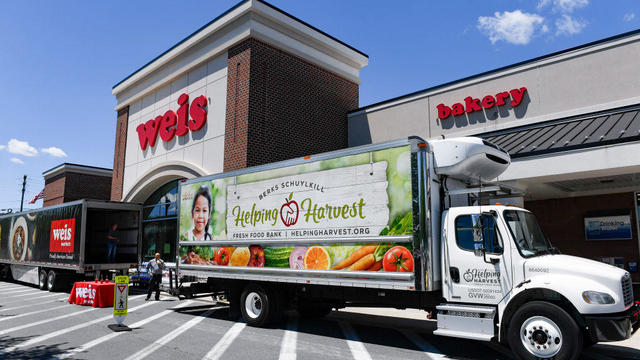 Weis grocery store is pictured, a truck that says Helping Harvest is parked in front of the store 