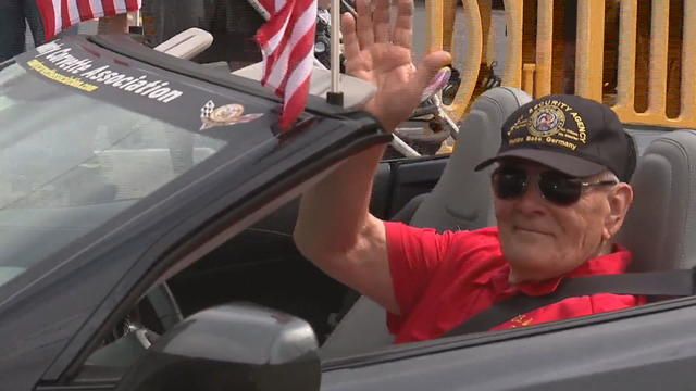 A veteran waves as he rides in a convertible in a Memorial Day parade in Media 
