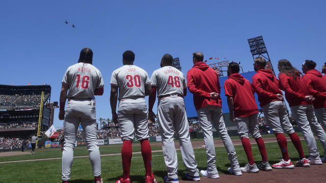 Philadelphia Phillies players stand during the national anthem at the Giants ballpark in San Francisco 
