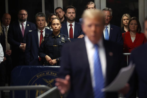 Sen. J.D. Vance listens as former U.S. President Donald Trump speaks to the media at his trial for allegedly covering up hush money payments at Manhattan Criminal Court on May 13, 2024 in New York City.