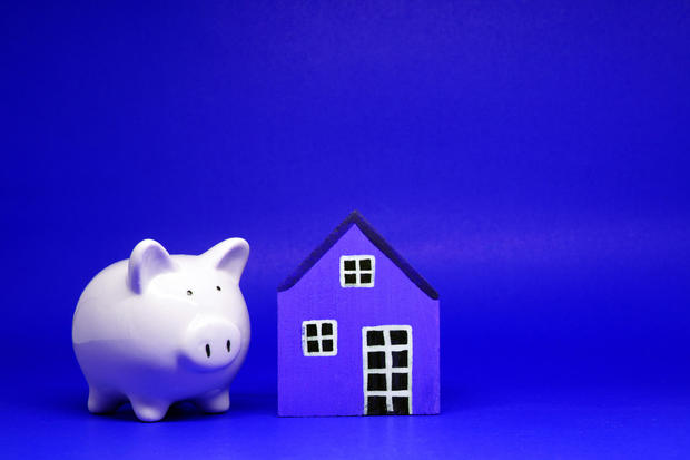 Fund , Investment , Saving money concept : Mock up White Piggy bank and House on blue background with copy space for text message - red pattern of Bank and Saving , benefit concept 