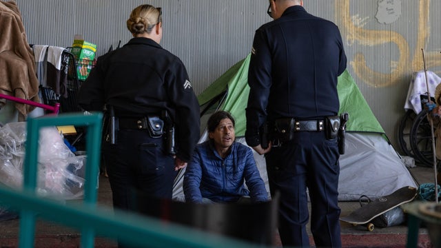 Mayor Karen Bass's Inside Safe team clears an encampment on Cahuenga Boulevard under the 101 Freeway 