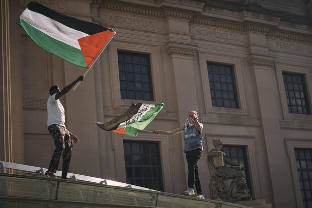 Pro-Palestinian demonstrators wave flags over the Brooklyn Museum during a protest demanding a permanent cease-fire in Gaza on Friday, May 31, 2024, in the Brooklyn borough of New York. 