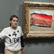 Environmental activist sticks protest poster to Monet's "Poppy Field"