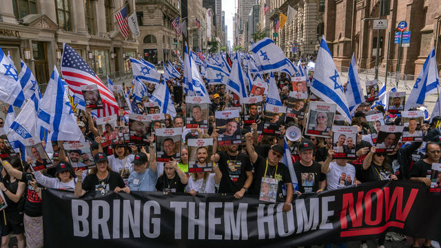 People, including the families of hostages, walk at the front holding a 'Bring them home now' sign at the the Israel Day on Fifth parade on June 2, 2024 in New York City. 