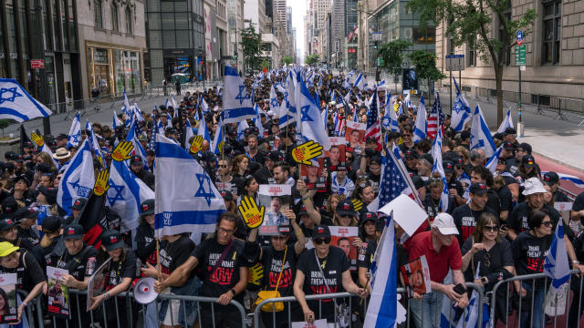 People hold Israeli flags as they take part in the Israel Day on Fifth parade on June 2, 2024 in New York City. 