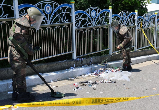 South Korean soldiers examine several objects, including what appeared to be debris from a balloon believed to have been sent by North Korea, in Incheon