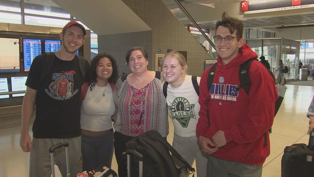 Philadelphia Phillies fans stop for a photo at Philadelphia International Airport ahead of the team's series in London 