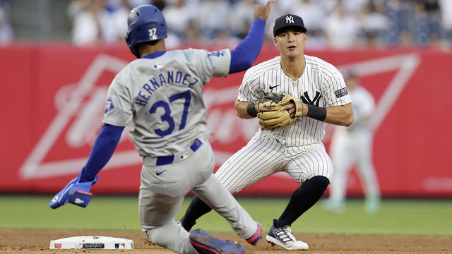 Anthony Volpe #11 of the New York Yankees looks to complete a second inning double play after forcing out Teoscar Hernandez #37 of the Los Angeles Dodgers against the at Yankee Stadium on June 07, 2024 in New York City. 