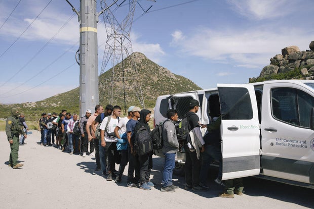 Migrants are processed by Border Patrol agents after crossing the U.S.-Mexico border on June 9, 2024, in Jacumba Hot Springs, California.