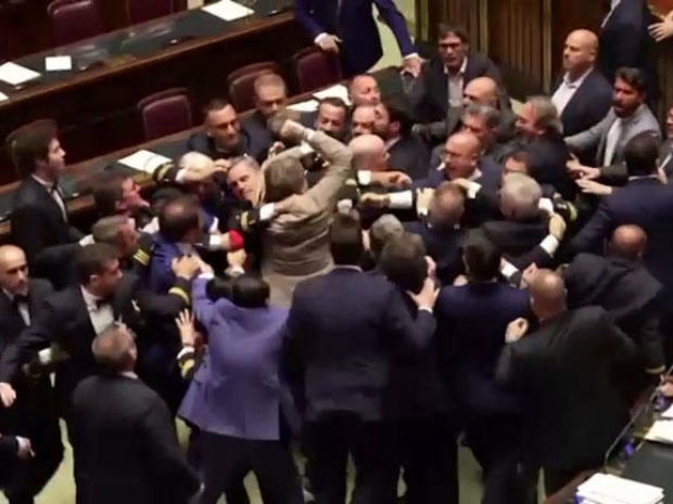 Italian lawmakers fight in Italy's Parliament in Rome, June 12, 2024, in an image capture from video. 