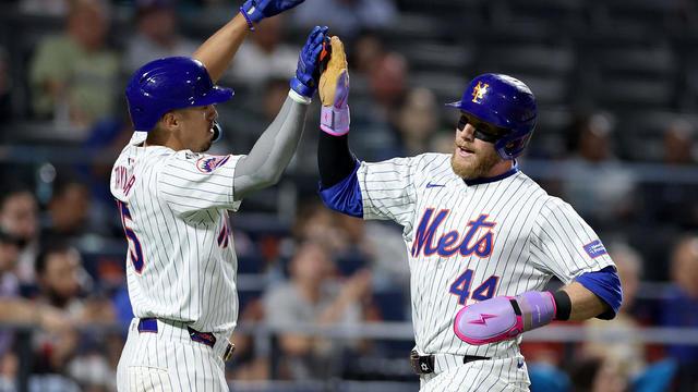 Tyrone Taylor #15 of the New York Mets congratulates teammate Harrison Bader #44 after Bader scored in the eighth inning against the Miami Marlins at Citi Field on June 12, 2024 in the Flushing neighborhood of the Queens borough of New York City. 