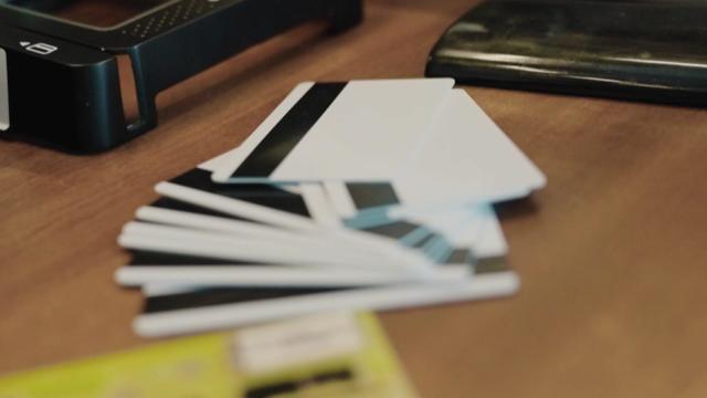 A pile of cards with magnetic strips on a desk. 