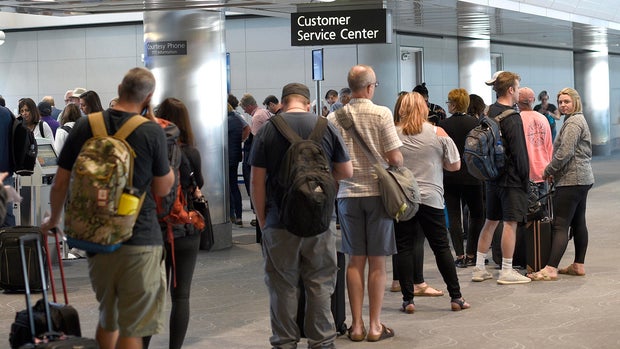 Airplane passengers at United Airlines Customer Service Center
