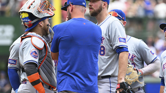 Pitching coach Jeremy Hefner #65 of the New York Mets visits the mound to speak with Tylor Megill #38 of the New York Mets during the first inning of a game against the Chicago Cubs at Wrigley Field on June 22, 2024 in Chicago, Illinois. 