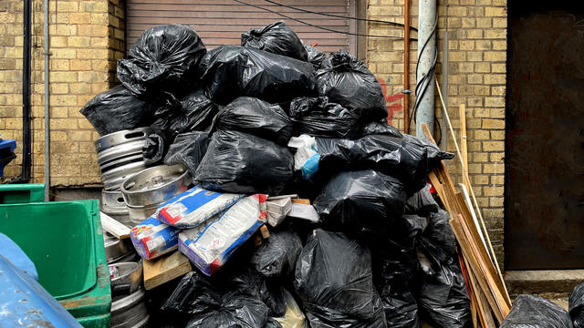 Pile of bin bags in a street 