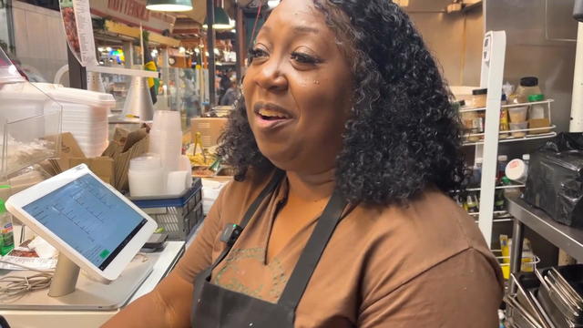Careda Matthews serves a customer with a smile at Reading Terminal Market 