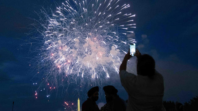 Spectators watch the fireworks show on July 4th in Washington, D.C. 
