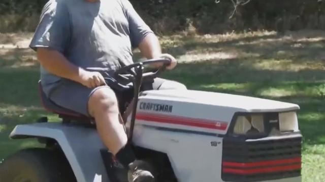 guy on riding mower 