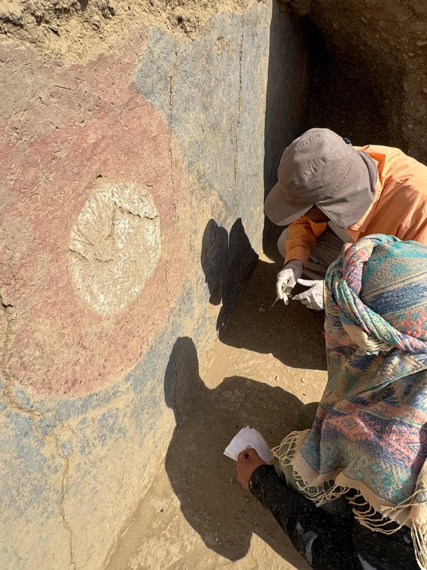 Archaeologists work on what's believed to be part of a 4,000-year-old ceremonial temple, found buried in a sand dune of northern Peru, in Lambayeque