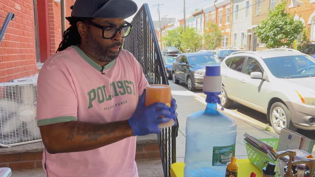 Montay Vincent shakes a fresh lemonade at Squeeze to Please lemonade stand 