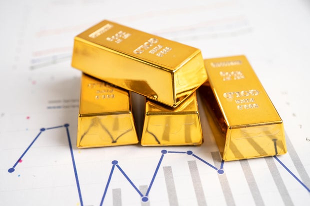 Gold bar on graph, economy finance exchange trade investment concept.