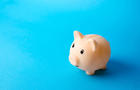 Piggy bank on a blue background. Economy. Pension fund. Deposit banking. Earn more money and save assets from inflation risks. Financial literacy, smart money management. Savings program 