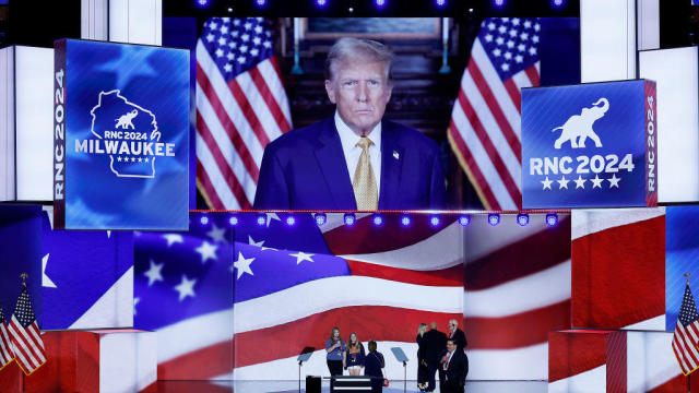 Donald Trump is seen on the stage screen as preparations are underway for the second day of the Republican National Convention at the Fiserv Forum on July 16, 2024, in Milwaukee, Wisconsin. 