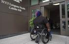 Dustin Jones pushes his wheelchair into NYU Langone Health Cobble Hill. 