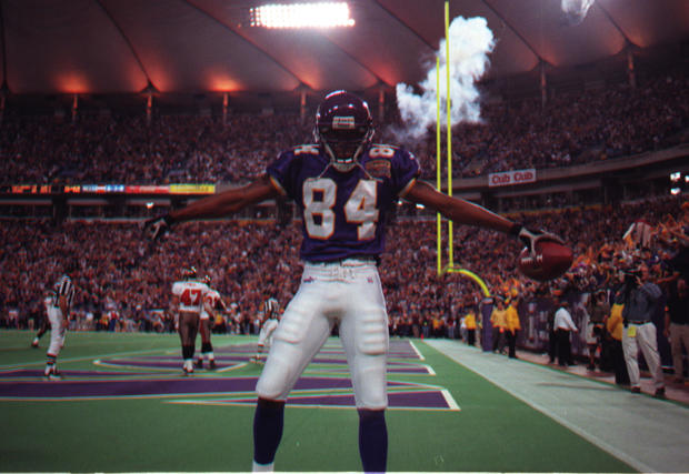 Randy Moss has a quiet moment before jumping into the estatic crowd to celebrate this fourth-quarter touchdown placing the Vikings in the lead 27-23. He caught a 45-yard pass from Daunte Culpepper. 