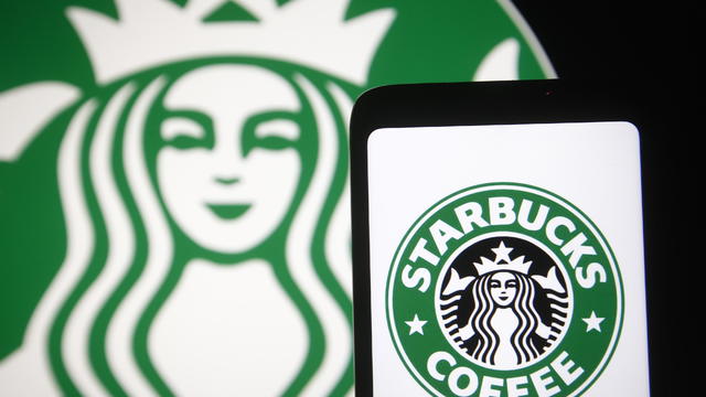 In this photo illustration, Starbucks logo is seen displayed 