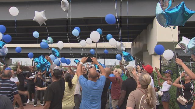 Friends and relatives release blue balloons near the site of a hit-and-run in Philadelphia 